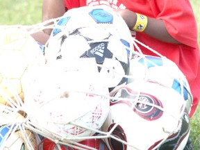 Heroes on the Move camper,Elishama Pierre hangs onto soccer balls during Thursday (July 4, 2013) night’s game.