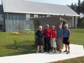 The Simcoe Lions Club has contributed $5,000 for a concrete walkway to a pergola at the rear of Norview. From left, Keith Ashley, Lions president Glenford Deming, Val Holland of Norview, Mark Rell and Dave Stelpstra.  (CHRIS THOMAS Special to Times-Reformer)