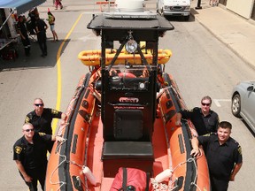 Members of the Owen Sound Fire Department pose with their Zodiac rescue boat in this Sun Times file photo.