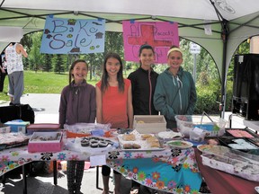 Mackenzie Tindal, Rianne Hambly, Olivia Vieira, and Dallis Loran sell baked goods at the Banff Farmers Market last Wednesday to raise funds for Red Cross and the recent flooding crisis. TERA SWANSON/ CRAG & CANYON/ QMI AGENCY.