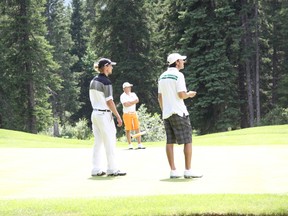 Watching an approach shot to the 18th green are, left to right, Chris Cooke, Ryan Werre and Scott Desmarais on Sunday, July 7, 2013. Desmarais went on to win the Canmore Men's Open played at the Canmore Golf & Curling Club. Russ Ullyot/ Crag & Canyon/ QMI Agency