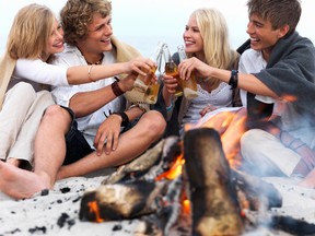 Young group of people sit by a bonfire at the beach drinking beer. Drunk gals provoke sex at least that's what one in five Canadians think, according to a new survey from the Canadian Women's Foundation released Tuesday.
Fotolia photo