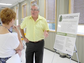 Tom Beaton, the municipality's manager of parks, cemeteries and horticulture, speaks with tree bylaw supporter Joanne Martin during Tuesday's open house at the Thames Campus Arena. The municipality is currently seeking feedback on forest cover strategies. (TREVOR TERFLOTH, The Daily News)