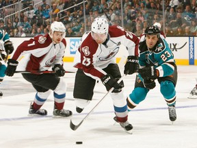 Scott Gomez, of the San Jose Sharks, chases after Milan Hejduk, of the Colorado Avalanche, during an NHL game on January 26, 2013 at HP Pavilion in San Jose, California. (AFP)