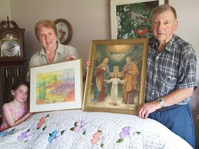 Stan and Marcy Korczak and their granddaughter Chantelle display the treasured possessions they were able to recover.
