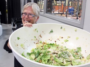 Pat Parker of Pats Palate Pleasers holds a caesar salad she had just made and was taking out to the buffet at the Bow Valley High formal at Spray Lakes, June 28.