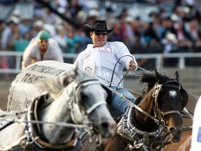 Jordie Fike of Cremona, now of High River, races around the first corner during day 3 of the Calgary Stampede Chuckwagon race, July 7.