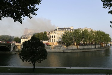 Firemen fight a blaze at the 17 century Hotel Lambert on July 10, 2013 in Paris. Hotel Lambert, by the architect Louis Le Vau located at the tip of the Ile Saint-Louis in Paris, was purchased in 2007 by the brother of the Emir of Qatar and currently being restore.    AFP PHOTO / KENZO TRIBOUILLARD