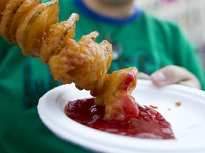 Sandra March has a hurricane potato during last year’s A Taste of Edmonton at Churchill Square. The festival of food returns July 18-27 with some new twists. File photo/QMI Agency.