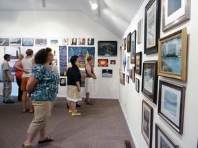 A group of art enthusiasts enjoys the exhibit.
Photos by SERGE ALLAIRE/FOR THE STANDARD