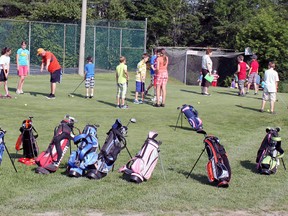 Golf bags encircle the practice putting green as junior golfers recieved their first day of lessons. While some practised their chipping, others practised their putting while a group perfected their drive. 
Photo by Dawn Lalonde/Mid-North Monitor/QMI Agency