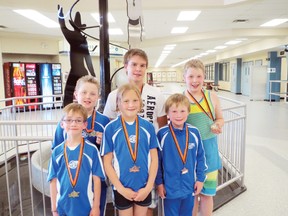 The Wetaskiwin Olympians show off their well earned hardware in Wainwright Torpedoes Invitational Swim Meet July 6. Pictured here are: back row, Ethan Elliot, left, Austin Jerke, and Jared Elliot. In the front row, Teague Rasmuson, left, Katia Rasmuson, and Michael Tremaine.