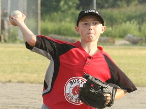 Samuel Laforge of the North Bay mosquito division Red Sox pitches during a game against the Moose's Cookhouse Giants at the Optimist Club Park, Monday. The Red Sox won 12-9.
