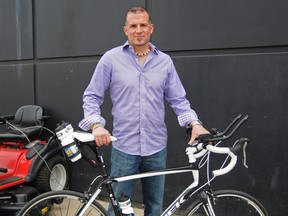 Elizabeth McSheffrey/Daily Herald-Tribune
Grande Prairie Canadian Tire manager Ron Regnier stands beside the bike that will take him 500 kilometres from Hinton to Calgary on a fundraising trip for Jumpstart this week. As of Wednesday Regnier had raised more than $17,000 for the national charity, which helps underprivileged children participate in team sports and recreation.