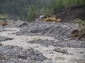 Excavators work in Exshaw creek on Monday, June 24, 2013. The Hamlet of Exshaw was hit hard by floodwaters rushing down Exshaw creek. Estimates indicate that of the hamlet's roughly 220 properties, 100-120 have been impacted. Justin Parsons/ Canmore Leader/ QMI Agency