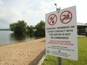 This sign, posted by the North Bay Parry Sound District Health Unit, is located at the dock off Big Moose Road at Lake Nosbonsing. It warns that toxic algae has been reported in the water.