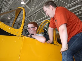 Yellow Wings program coordinator Alex Campbell explains the cockpit of a Fairchild Cornell to air cadet Stew Norval of Janetville, Ont., Wednesday, July 10, 2013, at the Canadore aviation campus. About 120 cadets from across the country are in North Bay for courses this summer, with 50 of them getting an opportunity to fly in vintage trainers from the Second World War era.