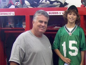 Jarrett Costron, then 11, poses with then Calgary general manager Jim Barker in the Stampeders’ locker room in 2006. Costron, now 19, is working for the Toronto Argonauts as a summer intern in the player personnel department, a job for which Barker, now the Toronto GM, hired him.