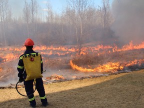 A member of Regional Emergency Services oversees a controlled fire. Burning off dried leaves and grasses that are revealed once the snow melts helps to stave off spontaneous wildfires from occurring in the future. TODAY FILE PHOTO