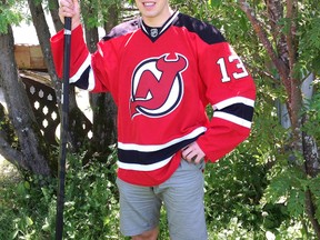 Iroquois Falls native Ryan Kujawinski poses with the New Jersey Devils' jersey he received after being drafted in the third round (73rd) of the 2013 NHL Entry Draft.