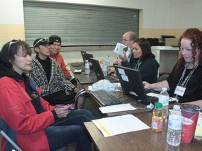 Members of the Eden Valley Reserve, west of Longview, Alberta, registered for the provincial flood relief program on July 8, to help offset some of the costs and losses suffered during the June 20 flood. on the left side are Logan Dixon, Troy Kootenay and Eleanor Potts. On the right are Bill Alles, Fawna Dixon and Brenda Devolin, helping with registraiton for Alberta Human Services.