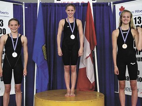 Local swimmer Christy Wright (centre) made it to the top of the podium at last weekend’s Alberta Age Group and Senior Championships swim meet. After the meet, Wright moved up the list to become the second-ranked swimmer nationally in the 50-meter breaststroke in the 13-16 age group. Next up for Wright are the national age group championships.