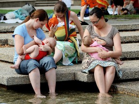 (left to right) Stefani Occhipinti and her son Marco Occhipinti, 7 months-old, Orla Olivieri and her daughter Angela Olivieri, 12 weeks-old, Rebecca Cameron and her daughter Brynn Cameron, 9 months-old, breastfeed at the Alberta Legislature fountains in Edmonton, Sunday Sept. 9, 2012. The group was taking part in the Breastfeeding Action Committee of Edmonton's celebration of the 10th anniversary of a change to civic policy that had previously blocked women from breastfeeding at public pools.  DAVID BLOOM EDMONTON SUN  QMI AGENCY