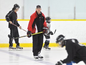 Eddie Chau Simcoe Reformer
Hockey coach Ryan VandenBussche keeps an eye out on his students during an on-ice warm up skate Thursday morning during the Tri-County Pros Hockey School at the Simcoe Recreation Centre. The School continues Friday.