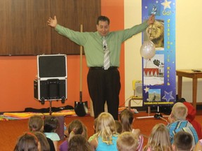 Magician Steven Dickenson shares his talent with young locals at the library Wednesday.