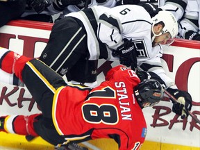 Los Angeles Kings Jake Muzzin hits Calgary Flames Matt Stajan during their Feb. 20, 2013 regular season game. Muzzin will be on-hand when the Woodstock Navy Vets hold their summer mini camp this weekend at Southwood Arena. Muzzin will speak to the players, who will continue the weekend with scrimmages, a fitness combine and educational seminars. Jim Wells/QMI Agency file photo