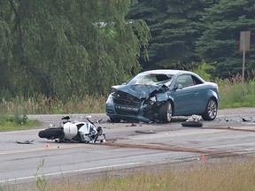 County of Brant OPP closed Cockshutt Road at Indian Line, south of Brantford, Ontario for several hours on Thursday afternoon, July 11, 2013 to investigate a fatal, head-on collision between a car and motorcycle.  Police say the motorcycle crossed the centre line on the sweeping curve for an unknown reason. The female driver of the car was taken to Brantford General Hospital and later released. (BRIAN THOMPSON Brantford Expositor)