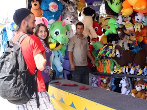 The Beauce Carnaval is in full swing at Timmins Square and there’ s plenty of activities to go around for everyone. At Pat Doucet’s (a.k.a. “The Canette Guy's”) game booth, Billy Alexander, left, and Kaylila Lefort try their hand at winning a prize. They ended up walking away with a stuffed animal for their efforts.