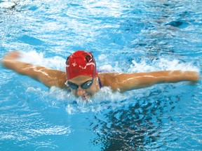 A Kenora Swimming Shark flies out of the water at practice at the Kenora Recreation Centre on Tuesday, July 9. The Swimming Sharks just returned from the Manitoba Saskatchewan provincial swim meet in Winnipeg. 
GRACE PROTOPAPAS/FOR THE ENTERPRISE