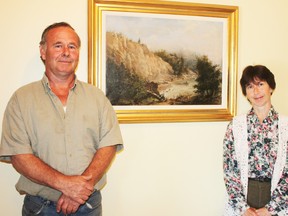 Jim and Lisa Kelly pose with their recent buy, a painting by pioneer Harpurhey artist William Nicoll Cresswell.