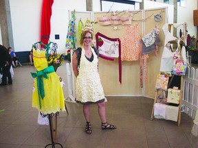 An artist stands by rows of functional art during last year’s Art in the Plaza. Photo Supplied