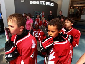 Ranon Joseph (right) prepares for Marc Lajoie (left) to lead Team Brick onto the ice as the 24th Annual Super Novice Hockey Tournament announces this year’s team at West Edmonton Mall Ice Palace on Thursday, June 27. Perry Mah/Edmonton Sun/QMI Agency