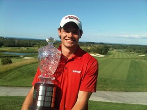 Stephane Dubois lifts the Golf Association of Ontario men’s amateur trophy Friday, July 12, 2013 after winning the tournament by five shots. (Photo courtesy of Dubois family)