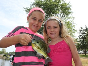 Kayla, left, and Sophie Smith, with a bluegill caught in the Napanee River.