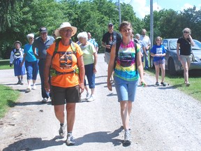 Sandi Pyper, left, and her daughter, Meagen, walk into the Pearce Williams Christian Centre property Friday after completing a 22-day walk to raise awareness for the centre. PATRICK BRENNAN QMI Agency