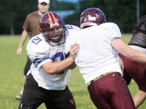 Nipissing Wild offensive lineman Matthew Bainbridge works on his pass blocking with teammate Kendal Reeder Friday at Rollie Fischer Field. The Wild visit Oakville Sunday in their OFC regular season finale with the playoffs on the line.