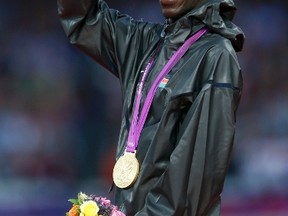 Kenya's Ezekiel Kemboi waves after receiving his gold medal during the men's 3000m steeplechase victory ceremony during the London 2012 Olympic Games August 6, 2012.  (Eddie Keogh, Reuters)