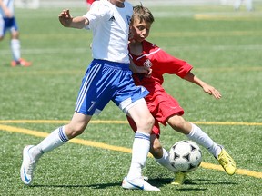 Dylan D'Agostino of the North Bay Selects Soccer Club under-13 boys team fights off North York Spartacus 2000s' Patrick Pasca during Central Soccer League Level 4 under-13 premier division play Saturday at Steve Omischl Sports Field Complex. D'Agostino scored for North Bay in a 1-1 draw.