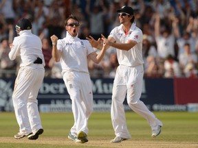 England’s Graeme Swann (centre), Ian Bell and Alastair Cook (right) celebrate after the dismissal of Australia’s Steven Smith during their match Saturday. (REUTERS)