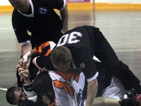 Referees attempt to seperate Sarnia Beaver Ryan Charteris (in white) from Brooklin Merchant Kiel Nizich after a fight while Charteris tries to land one last blow Saturday, July 13, 2013 at Clearwater Arena in Sarnia, Ont. PAUL OWEN/THE OBSERVER/QMI AGENCY