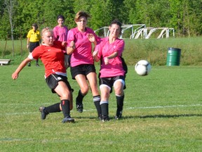 Owen Sound's Emily Bass blasts a ball past two St. Clements Lady Hawks defenders as she scored in the Sonics 3-0 win in SouthWest Region Soccer League women's consolation Cup play on Saturday July 13 at the Kiwanis Soccer Complex.