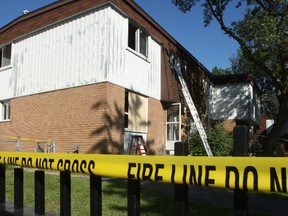 Contractors boarded up the windows and doors of this unit on Debra Avenue Sunday after an early morning fire forced the family of six people out. Police and fire officials are investigating the blaze which started in the basement. Doug Hempstead/Ottawa Sun