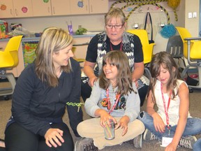 Elizabeth McSheffrey/Daily Herald-Tribune
Nine-year-old Reading University students Emma Lemky (centre) and Alexis Keays (right) get some positive reinforcement during a game of Zap! from instructor Carla Knezevich (left) and principal Helen Neufeld at the Grande Prairie Regional College Friday. The Grade 3 graduates are improving their literacy skills over a three-week course that teaches skills such as picture prediction, computer blogging, and choral reading.
