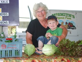 Cathy McGregor-Smith of McSmith's Organic Farm stands with grandson Cameron Harris at their booth at the Horton Farmers' Market in St. Thomas on Saturday, July 13, 2013. Ben Forrest/QMI Agency/Times-Journal
