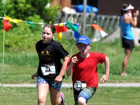 The 10th-annual Heart of Gold Triathlon attracted more than 150 participants with nearly a third of them under the age of 14 years old. 2013 marked the first time the triathlon has been included in the Ontario Youth Cup Series, as one of the four events throughout the province. Autumn Walton, left, and Desmond Brazeau sprint towards the finish line.