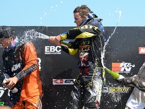 Jesse Wentland (left) was a little slow on the draw Sunday getting sprayed by Topher Ingalls (centre) and Dylan Wright on the MX2 podium at Gopher Dunes. Ingalls picked up 47 points in Round 5 of the Monster Energy Motocross Nationals at Gopher Dunes. CHRIS ABBOTT/TILLSONBURG NEWS